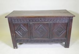 An C18th/C19th carved oak coffer with a plank top, adapted, 132 x 60cm high