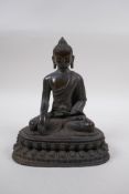 A Sino Tibetan bronze figure of Buddha seated in meditation, 21cm high