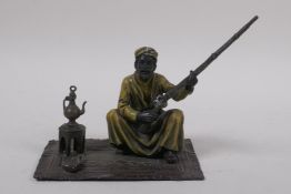 After Bergman, a cold painted bronze figure of a seated Arab with a rifle, 13 x 9cm