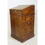 A Victorian rosewood davenport desk, with three quarter gallery and covered inkwell compartment,