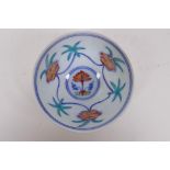 A Doucai porcelain tea bowl with raised lotus flower design to the exterior and floral decoration to