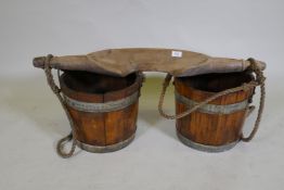 An antique milk maids shoulder yoke and wood buckets, yoke 90cm long