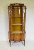 A Louis XV style marquetry inlaid rosewood vitrine with brass mounts, serpentine front, raised on