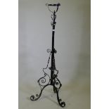 A Victorian wrought iron telescopic floor lamp stand, 150cm high, 186cm extended