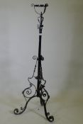 A Victorian wrought iron telescopic floor lamp stand, 150cm high, 186cm extended