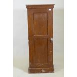 A late C19th/early C20th grain painted cupboard with panelled sides and door, rope twist carved