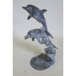 A bronze fountain in the form of two leaping dolphins, 80cm high