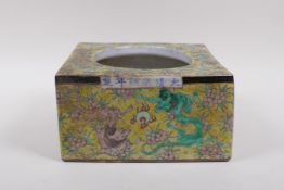 A yellow ground porcelain brush pot of square form with polychrome dragon decoration, Chinese KangXi