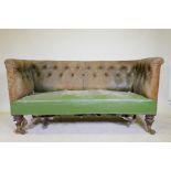 A C19th settee, with buttoned back leather back and arms, raised on mahogany turned tulip shaped