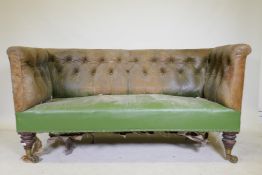 A C19th settee, with buttoned back leather back and arms, raised on mahogany turned tulip shaped