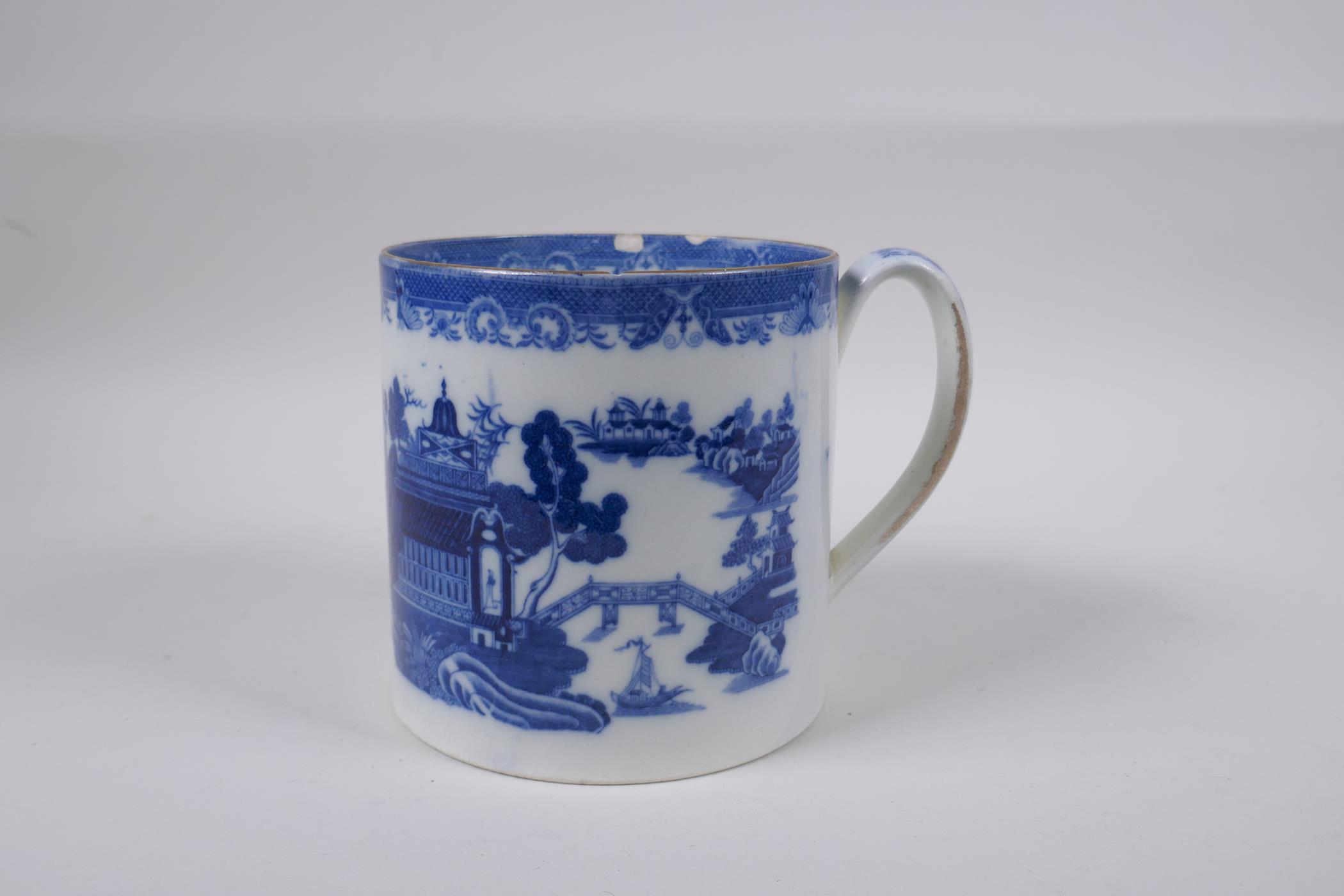 A C19th blue and white pearlware tankard decorated with a Willow style pattern, 13cm high x 13cm