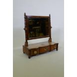 A C19th bowed front mahogany swing toilet mirror, the bevelled glass between ring turned supports,