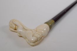 A bone handled walking stick, the handle carved in the form of a female nude, 88cm long