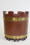 A brass bound teak bucket with castellated top, 34cm high