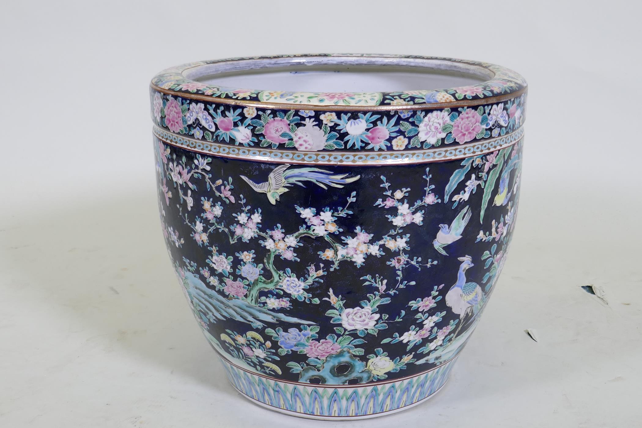 An antique Chinese famille noire ceramic jardiniere, decorated with exotic birds and flowers, 33cm - Image 4 of 7