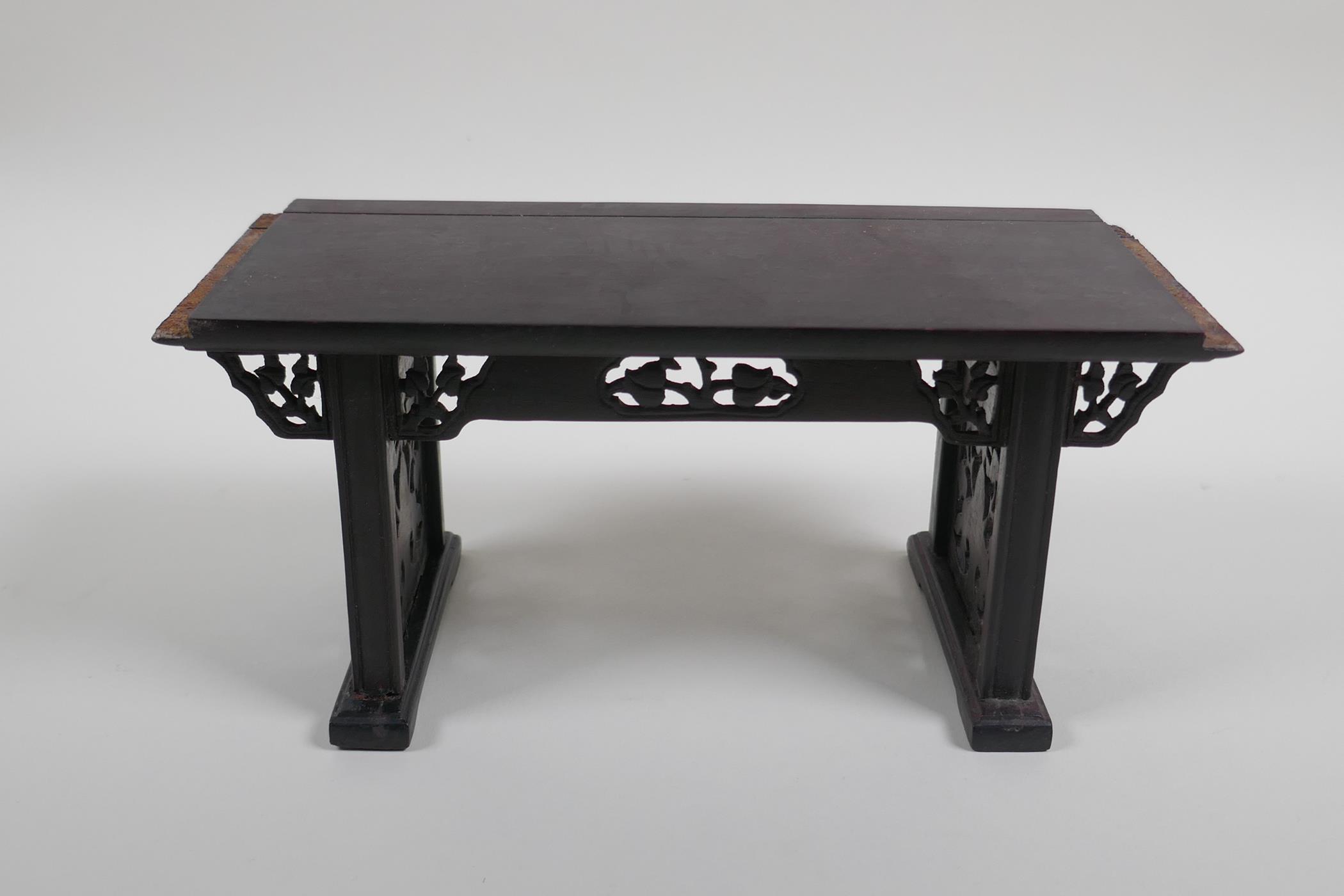 A Chinese carved and pierced hardwood stand in the form of a miniature altar table, 22cm wide - Image 2 of 4