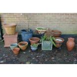 A quantity of terracotta, reconstituted stone and composition plant pots and planters, some with