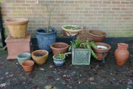A quantity of terracotta, reconstituted stone and composition plant pots and planters, some with
