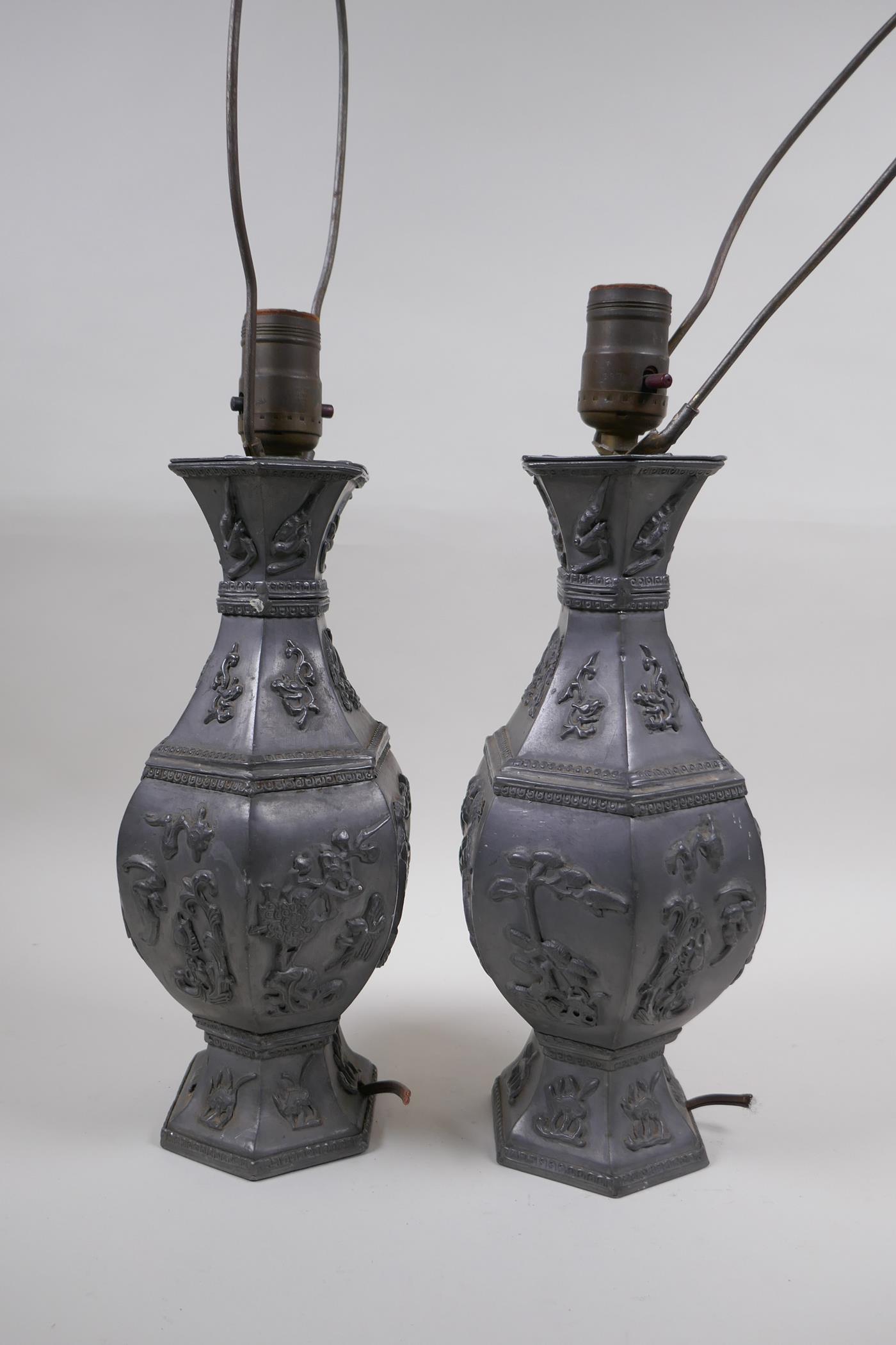 A pair of Chinese pewter lamps decorated with mythical creatures and auspicious symbols, 35cm high - Image 2 of 4