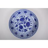 A blue and white porcelain charger decorated with peonies, Chinese Xuande 6 character mark to