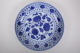 A blue and white porcelain charger decorated with peonies, Chinese Xuande 6 character mark to