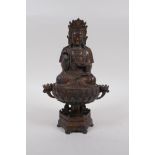 A Sino Tibetan gilt bronze Buddha, seated on lotus flower, 25cm high