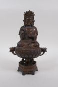 A Sino Tibetan gilt bronze Buddha, seated on lotus flower, 25cm high