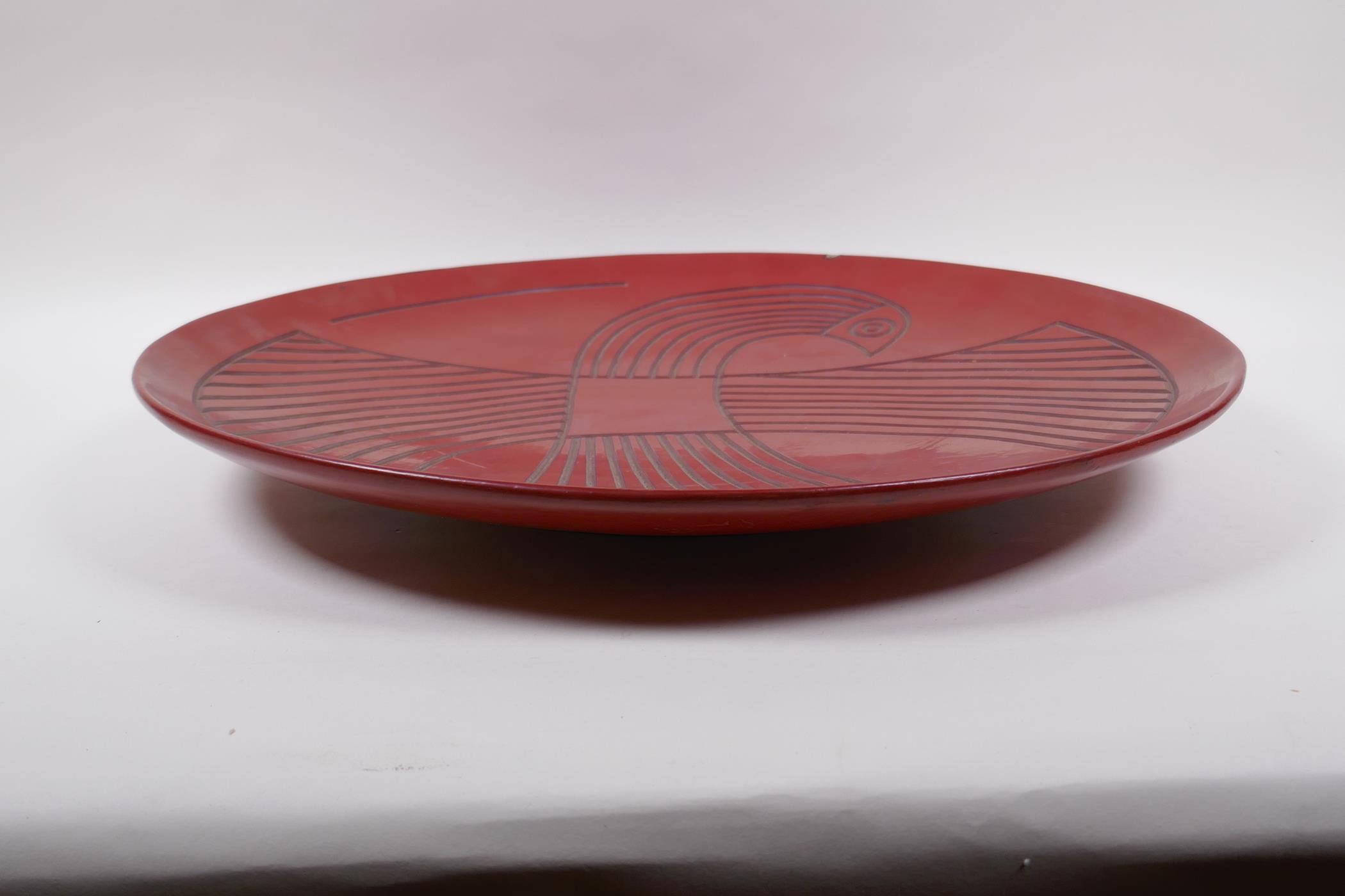 A Chinese red Tixi lacquer charger with stylised bird decoration, Xuande 4 character mark to base, - Image 3 of 8