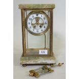 An American brass and onyx mantel clock, with brass and enamel dial and mercury pendulum, the