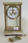 An American brass and onyx mantel clock, with brass and enamel dial and mercury pendulum, the