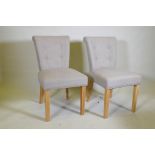 A pair of contemporary button back side chairs, raised on square tapering beechwood supports