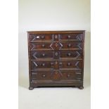 A Jacobean oak chest of five drawers, with moulded and bobbin turned decoration, raised on bun