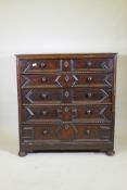 A Jacobean oak chest of five drawers, with moulded and bobbin turned decoration, raised on bun