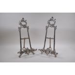 A pair of silver plated easel stands with swag decoration, 41cm high