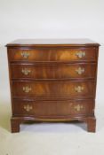 A mahogany serpentine front chest of four drawers, with brass plate handles, raised on bracket