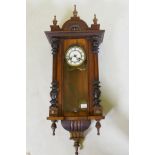 A C19th Vienna wall clock with walnut case and brass and enamel dial, the spring driven movement