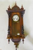 A C19th Vienna wall clock with walnut case and brass and enamel dial, the spring driven movement