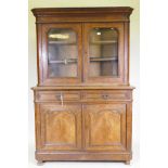 A C19th continental walnut bookcase, the upper section with two shaped glazed doors, the base with