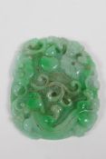 A Chinese mottled green jade pendant with carved kylin, ruyi and bat decoration, 7 x 9cm