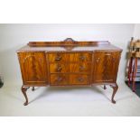 A Maples mahogany breakfront sideboard, with three drawers flanked by two doors, raised on