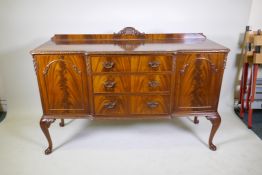 A Maples mahogany breakfront sideboard, with three drawers flanked by two doors, raised on