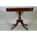 A Regency rosewood card table with satinwood inlaid borders, fold over top and inlaid frieze, raised