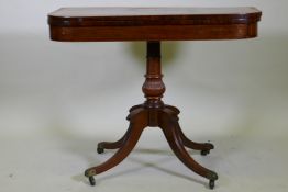 A Regency rosewood card table with satinwood inlaid borders, fold over top and inlaid frieze, raised
