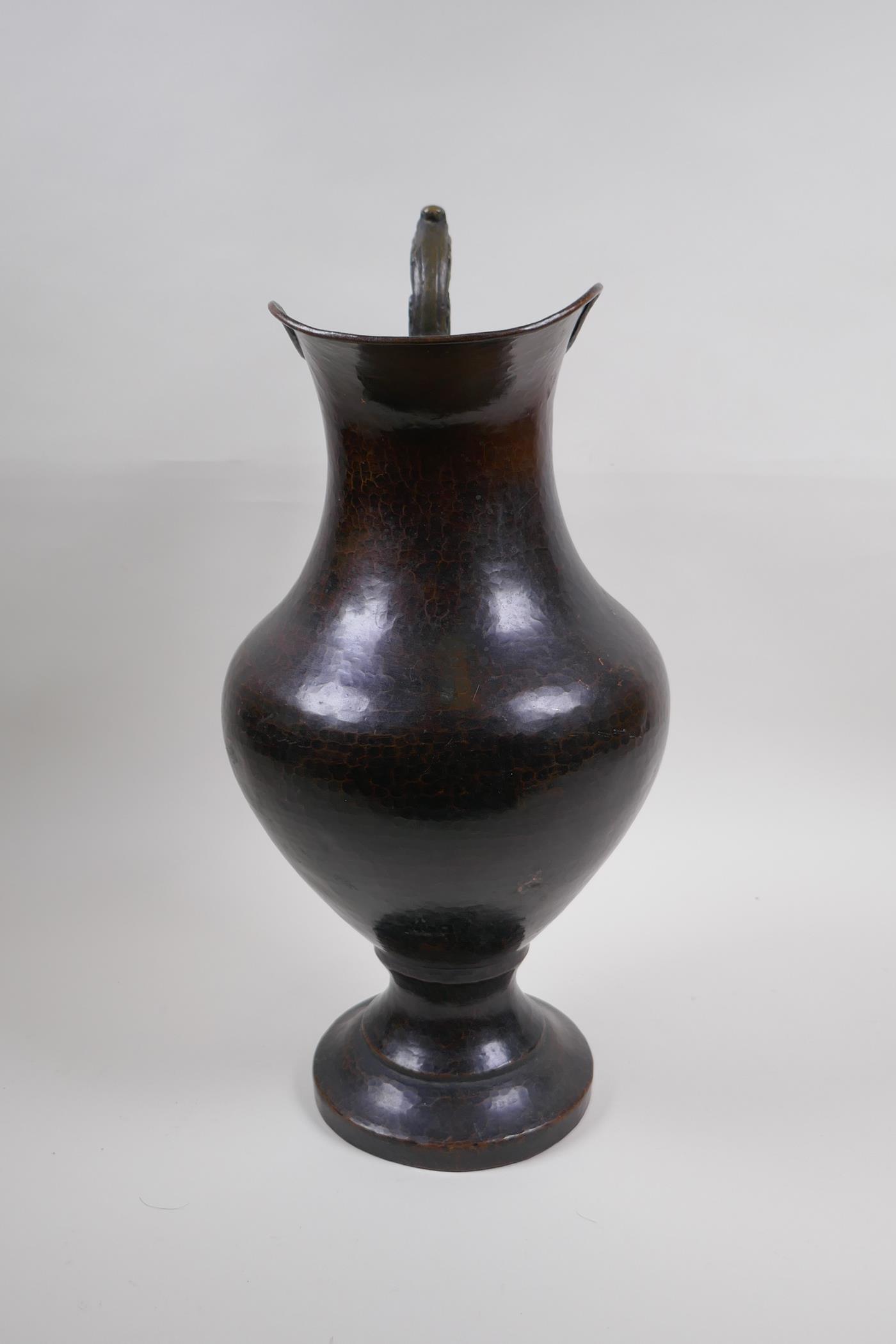 A patinated hammered copper urn with bronze handle, 39cm high - Image 3 of 6