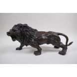 After Rodin, a bronze figure of a prowling lion, 31cm long