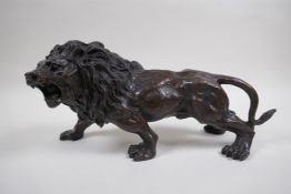After Rodin, a bronze figure of a prowling lion, 31cm long