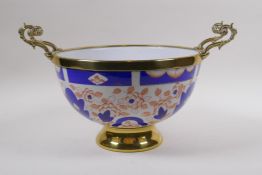 A brass mounted porcelain bowl/centrepiece, decorated in the Imari palette, 24cm diameter, mark to