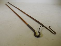 An antique shepherd's crook with blacksmith forged crook, 202cm long, and another similar and