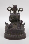 A Sino Tibetan bronze of a deity in prayer, 16cm high