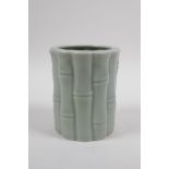 A Chinese celadon glazed porcelain brush pot moulded as bamboo, 12cm high x 10cm diameter